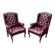 Load image into Gallery viewer, vintage oxblood faux leather tufted queen ann wingback chesterfield armchairs - a pair at EclecticCollective.com - Main Product Photo