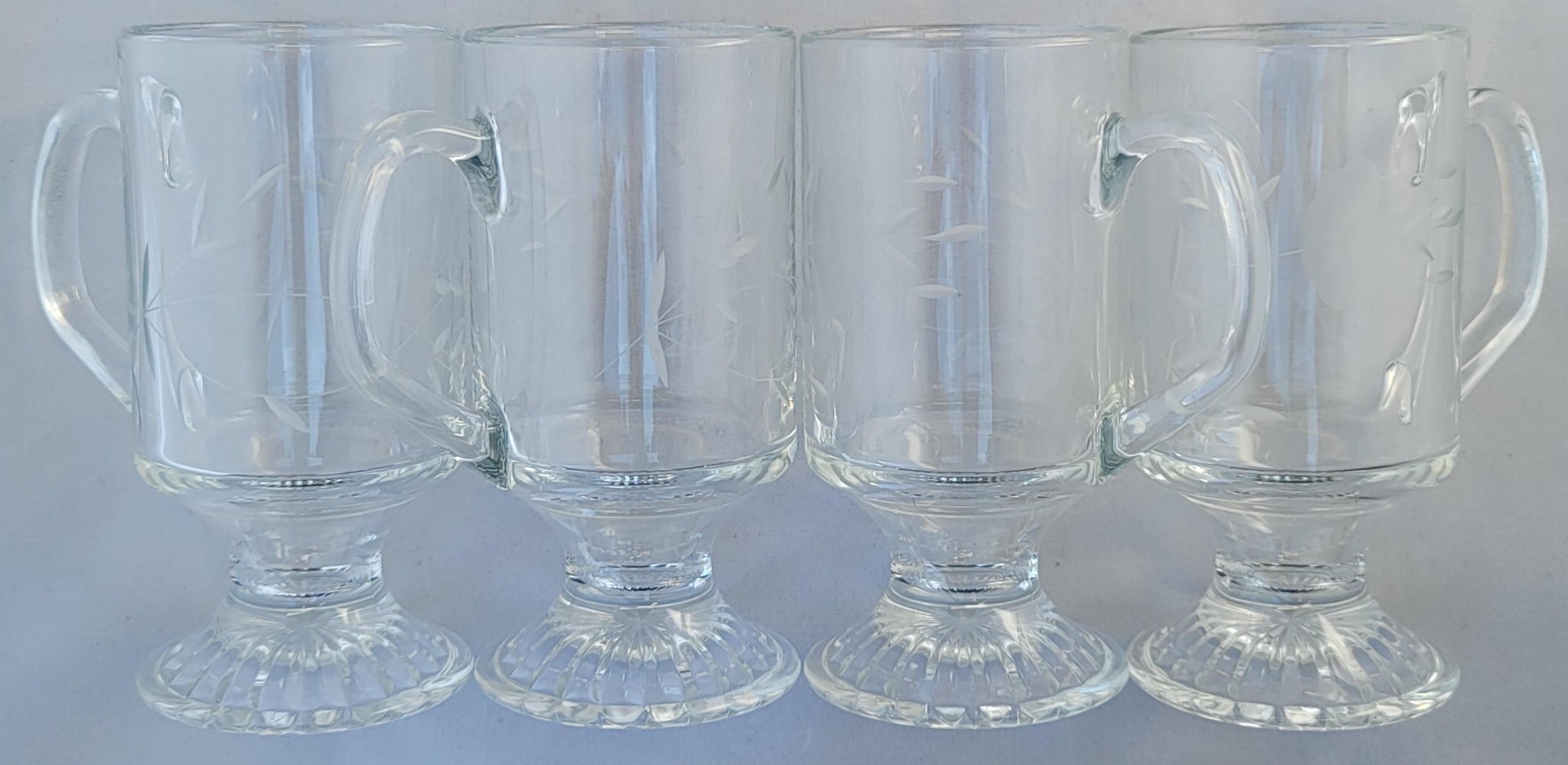 https://eclecticcollective.com/cdn/shop/products/vintage-1960s-princess-house-footed-clear-pressed-cut-glass-mugs-latte-glasses-set-of-4-1183_1024x1024@2x.jpg?v=1616126260