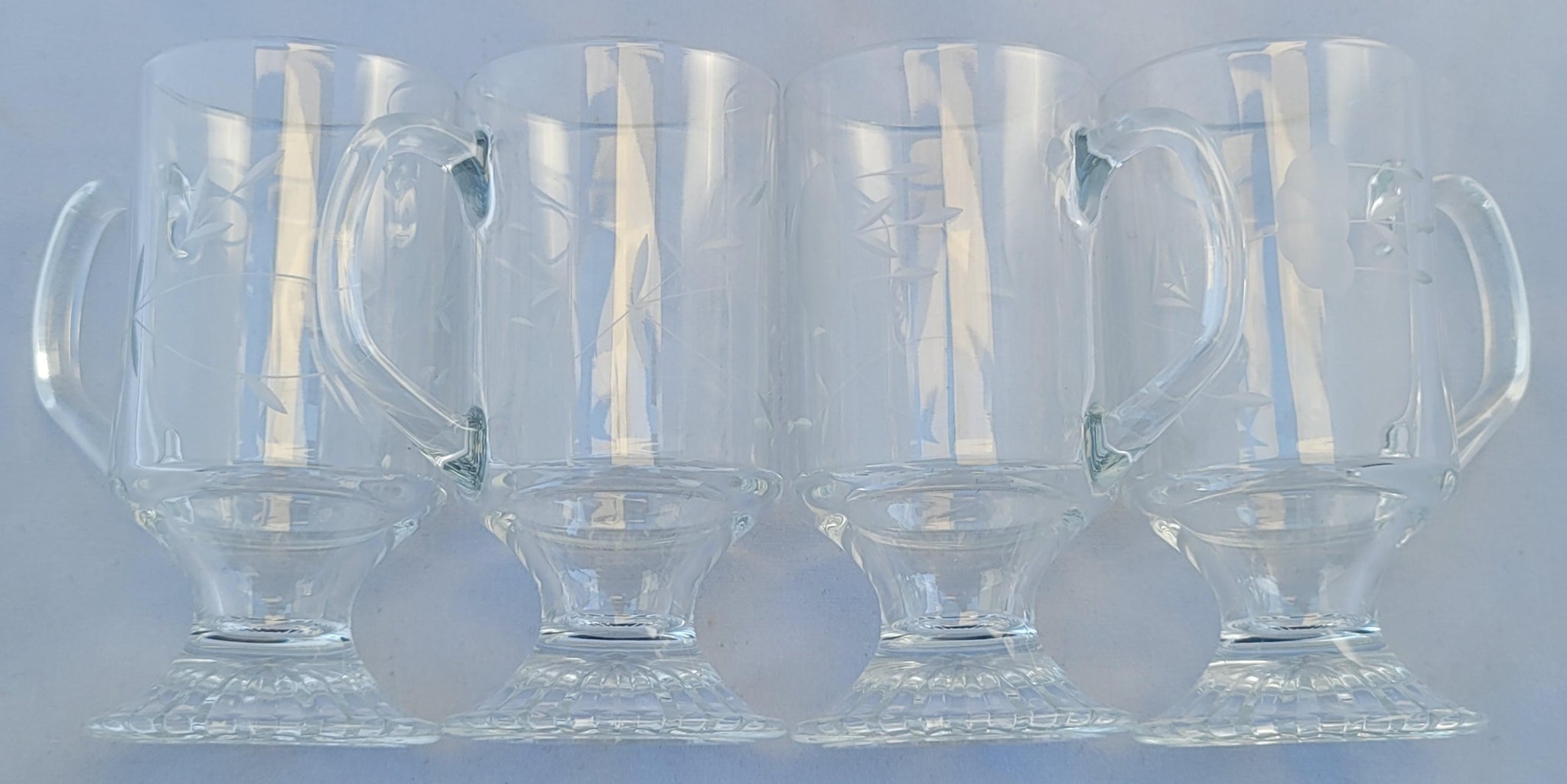 https://eclecticcollective.com/cdn/shop/products/vintage-1960s-princess-house-footed-clear-pressed-cut-glass-mugs-latte-glasses-set-of-4-1974_1024x1024@2x.jpg?v=1616126260