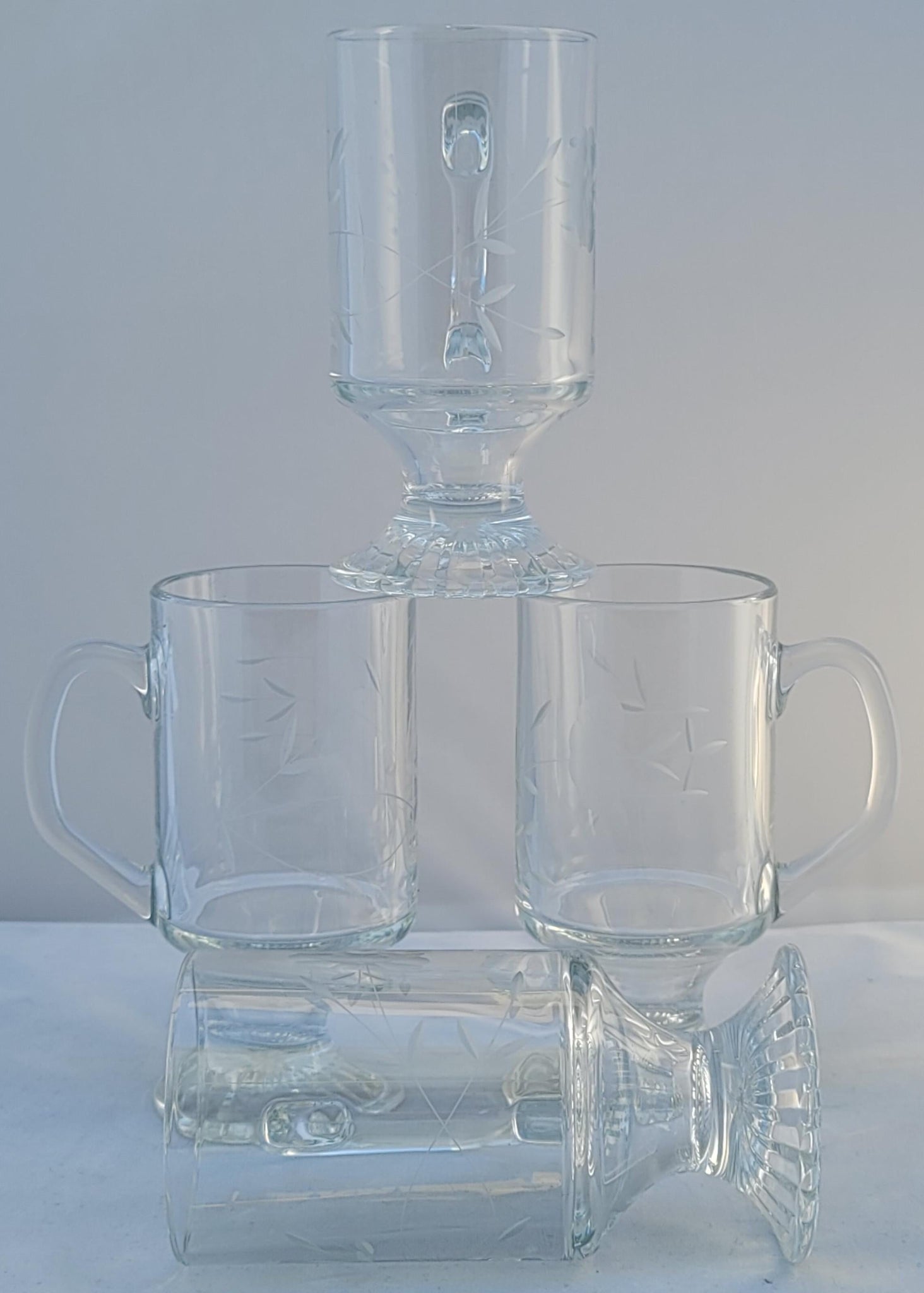 https://eclecticcollective.com/cdn/shop/products/vintage-1960s-princess-house-footed-clear-pressed-cut-glass-mugs-latte-glasses-set-of-4-4905_1024x1024@2x.jpg?v=1616126260